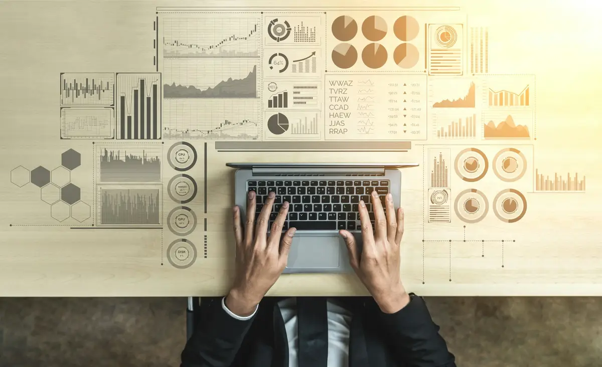 Analyst reviewing financial data on a laptop